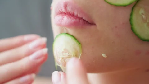 Close Hand View Placing Cucumber Slice on Face for Skin Care Routine Stock Footage 308593210