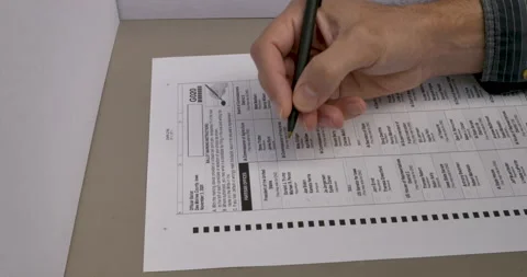 Close up of a hand voting for Joe Biden and Kamala Harris in a voting booth Stock Footage 137369490