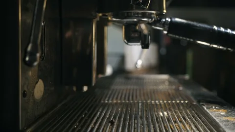 Close up of hand washing holder under the water jet of coffee machine Stock Footage 127586489