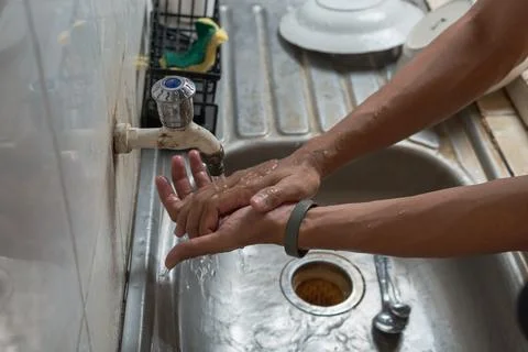 Close-up hand washing under a running tap Stock Photos