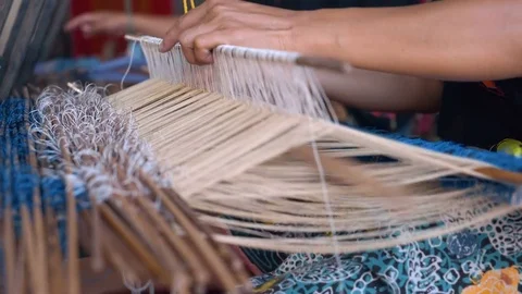 Close up of hand weaving with sticks, making traditional sarong in Indonesia 動画素材 79133822
