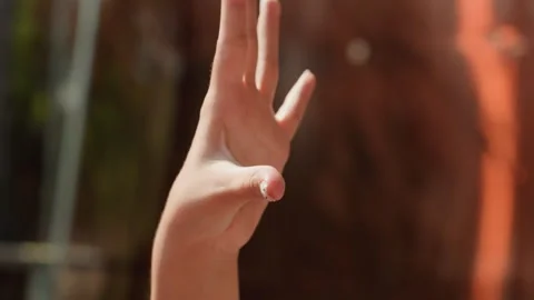 Close up of hand with white polka dot nail polish fingers moving in softly Stock Footage 345972041