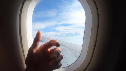 Close up hand on window of airplane Stock Footage 104225105