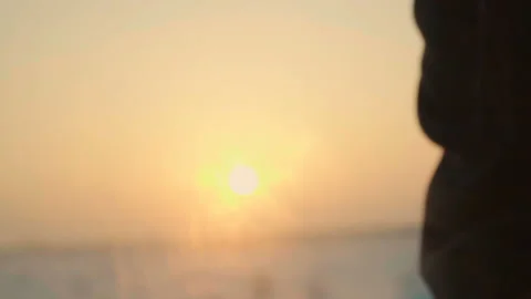 Close up hand wipes car window against sunset sunrise sky in slow motion Stock Footage 88119211
