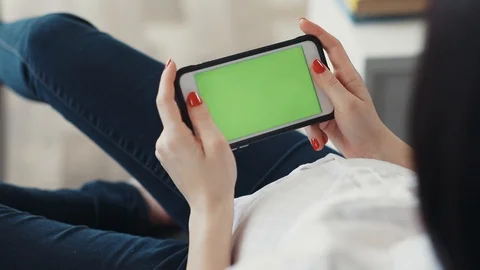 Close up hand woman sitting using hold horizontal phone with green screen gadget Stock Footage 87284273