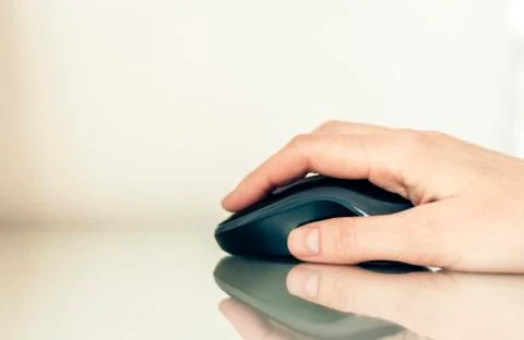 Close-up of hand woman using a computer mouse on glass table, business concep Stock Photos