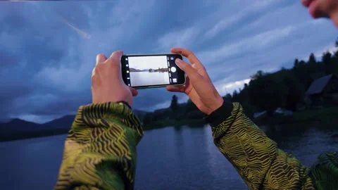 Close up hand woman using smartphone to take a photo of mountains lake while Stock-Footage 270053864
