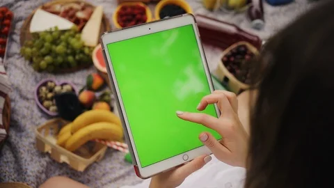Close up hand woman using a tablet computer with green screen background on a Stock Footage 92870285