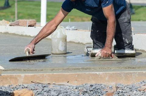Close up hand worker leveling concrete pavement for mix cement at construct.. Stock Photos
