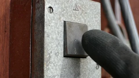 Close up of hand of worker pressing power button on a building Stock Footage 136756053