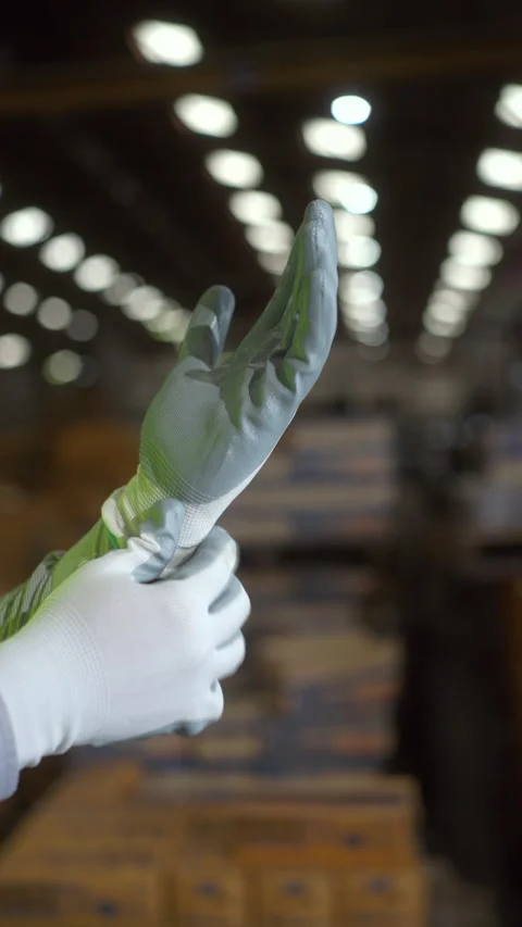 Close up hand worker wearing putting protective safety glove. Safety equipment f Stock Footage 287471749
