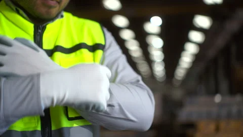 Close up hand worker wearing putting protective safety glove. Safety equipment. Stock Footage 287473562