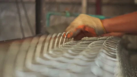 Close up hand worker working contone production machine steel wire mesh. Video stock 219994958