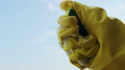 Close-up of a hand wringing out a cloth to remove excess water for further clean Stock Footage 301307611