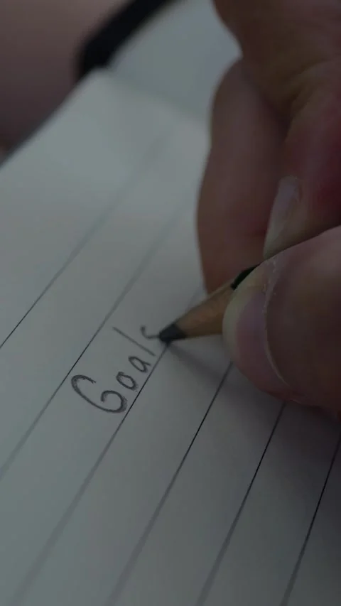 Close-up of a hand writing 2026 goals and resolutions on paper... Stock Footage 344455008