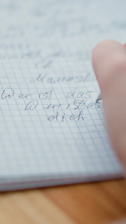 Close-up hand writing in cursive on wooden table Video stock 318216023