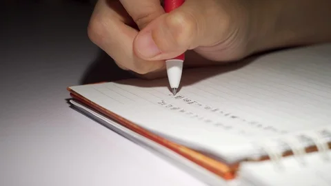 Close up of hand writing dairy in mandarin Stock Footage