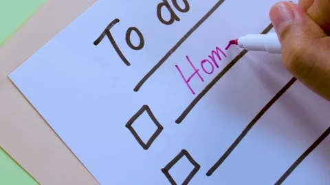 Close Up Hand Writing Homework on To Do List with Pink Pen Stock Footage 329537155