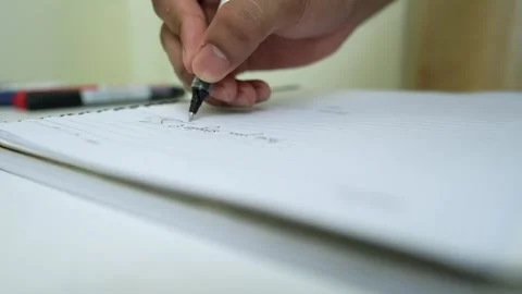 Close-Up of Hand Writing on Lined Paper Stock Footage 320726367
