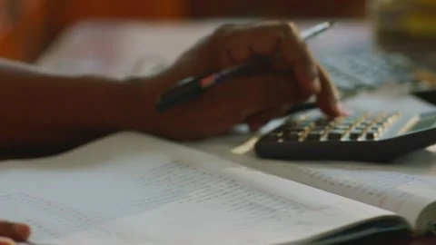 Close-up of hand writing in notebook with pen, warm light Stock Footage 327513449