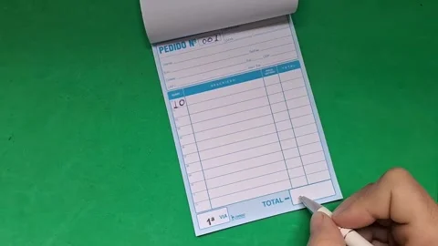 Close-up of a hand writing on a notepad with a pen. Business professional taking Stock Footage 340480652