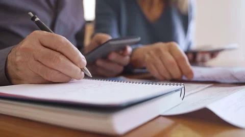 Close up of hand writing numbers and calculating taxes and budget Stock Footage 249755710