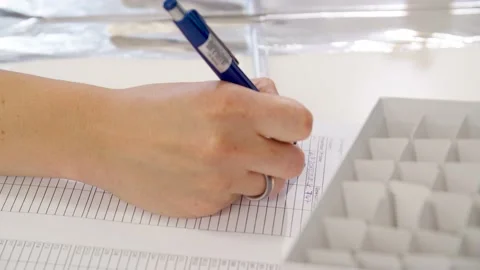 Close up of Hand writing on Paper with Blue Pen Stock Footage 145055835