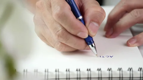 Close up hand writing paper on notebook with blue pen Stock Footage 201315980