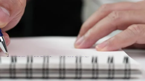 Close up hand writing paper on notebook with blue pen Video stock 201316387