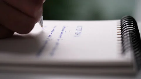 Close up hand writing paper on notebook with blue pen Video stock 201338307
