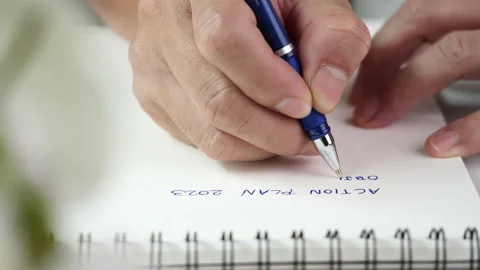 Close up hand writing paper on notebook with blue pen Vídeo Stock 202126231