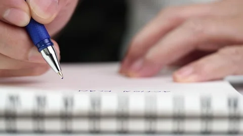 Close up hand writing paper on notebook with blue pen Video stock 202127435
