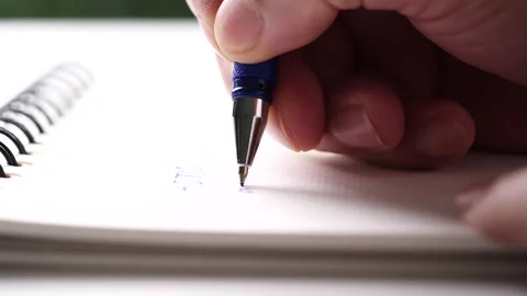 Close up hand writing paper on notebook with blue pen Video stock 202127545