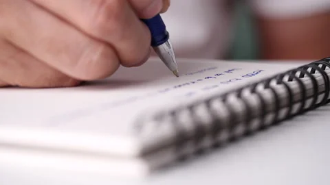 Close up hand writing paper on notebook with blue pen Video stock 202127761