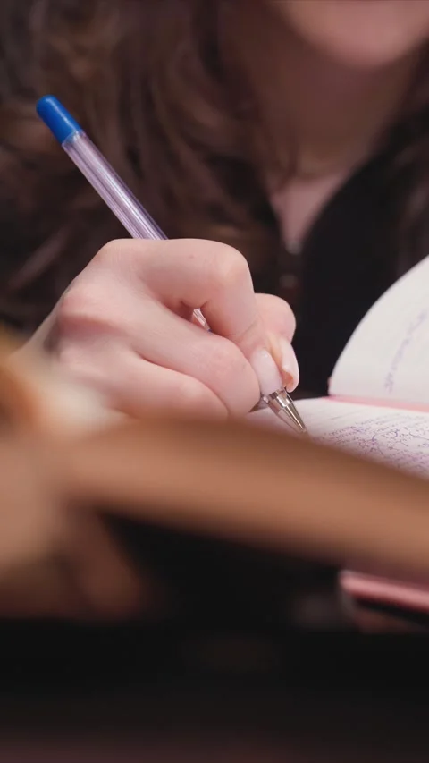 Close up Hand Writing Pen on Lined Paper Detail with notebook stationery purple Stock Footage 348162582