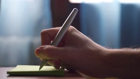 Close up of hand writing with pen on post it. Stock Footage 220616892