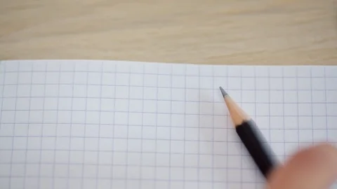 Close-up of a hand writing a pencil in a notebook Stock Footage 92046812