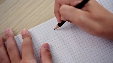 Close-up of a hand writing a pencil in a notebook Stock Footage 92047285