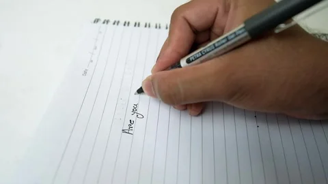 Close-up of a hand writing in a spiral notebook with a pen Stock Footage 320726198