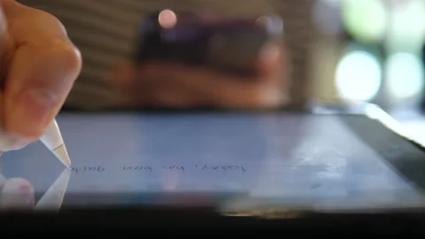 Close-up Hand Writing on Tablet with Stylus Pen in Coffee Shop Stock Footage 322007121
