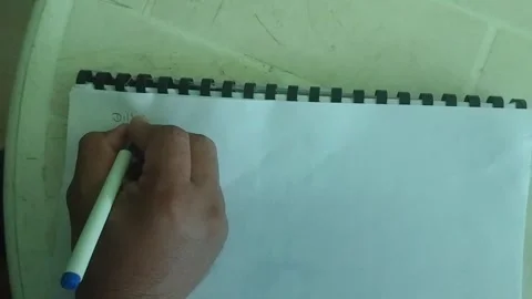Close Up of Hand Writing Text on Paper with Pen in Notebook Stock-Footage 346758041