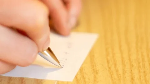 Close up on hand writing on white paper Stock-Footage 84385431
