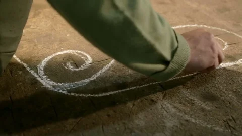 Close-up hand of a young blacksmith who draws a chalk sketch on the table Stock Footage 76362549