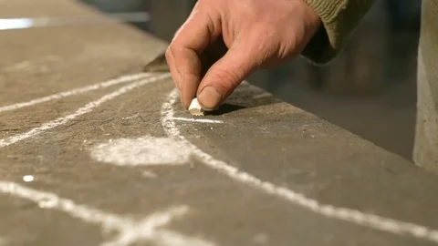 Close-up hand of a young blacksmith who measures and sign sketch on the table Stock Footage 76362993
