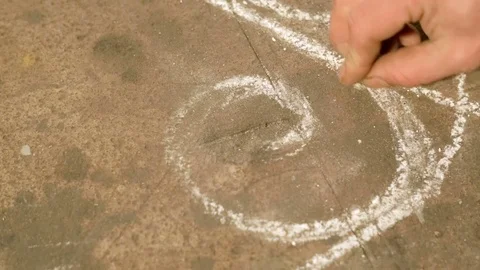Close-up hand of a young blacksmith who draws a chalk sketch on the table Stock Footage 77003167