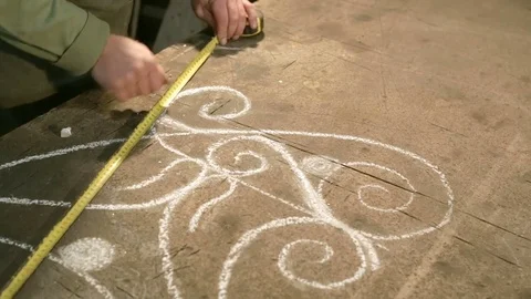 Close-up hand of a young blacksmith who measures and sign sketch on the table Stock Footage 77003295
