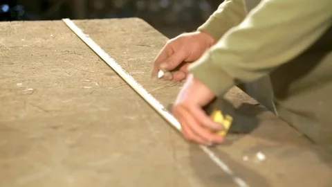 Close-up hand of a young blacksmith who measures and sign sketch on the table Stock Footage 77003384
