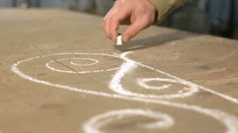Close-up hand of a young blacksmith who draws a chalk sketch on the table Stock Footage 77003829
