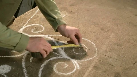 Close-up hand of a young blacksmith who measures and sign sketch on the table Stock Footage 77003948