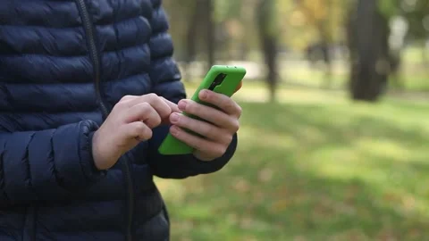 Close-up of the hand of a young guy holding a smartphone. Stock Footage 141462015
